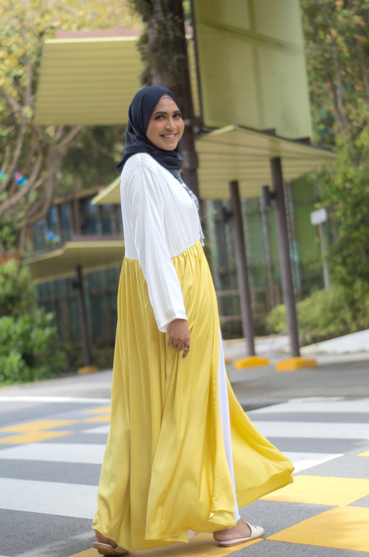 A long white and yellow abaya